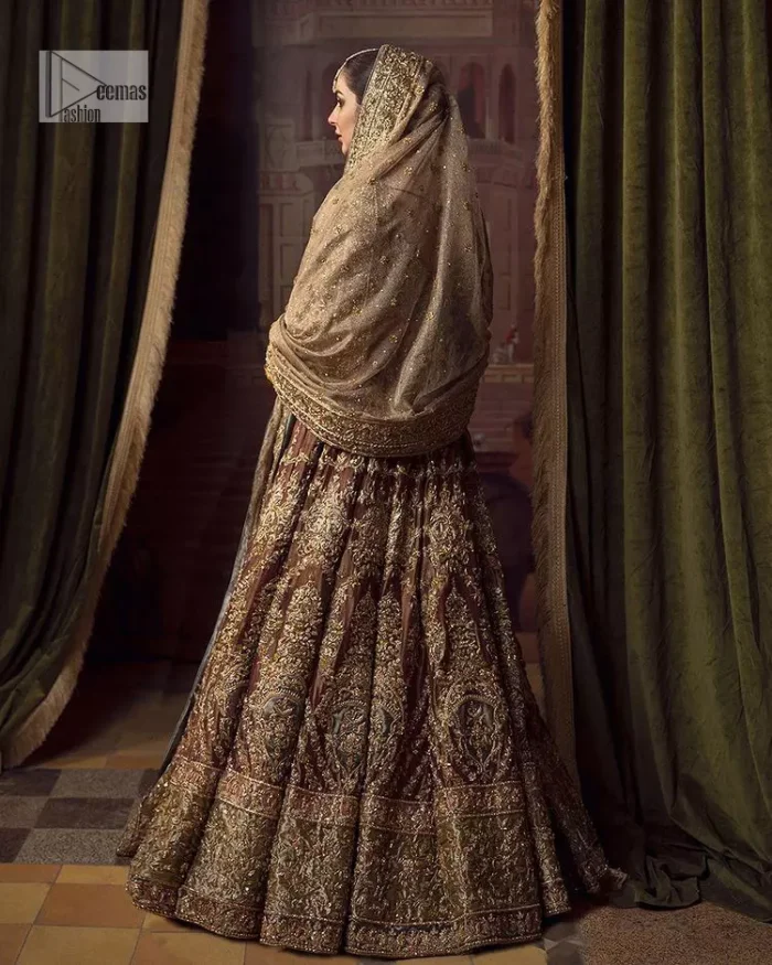 This alluring outfit is surely any girl’s dream. The hazel blouse is a magnificent choice which is ornamented with golden embroidery that wins everyone's hearts at the very first glance. It is further intensified with tilla, dabka, kora, Kundan and stones. Hand-crafted details on the full sleeves of this beautiful nikah dress make it the epitome of beauty. It is coordinated with a lehenga which is decorated with the finest details that are your first priority for the wedding. The lehenga has a huge flare to fulfil the dreamy look. Complete this article with a dupatta that is adorned with four-sided embellished borders and sparkling sequins to make your day.