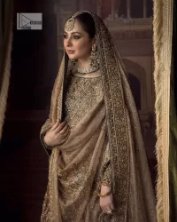 This alluring outfit is surely any girl’s dream. The hazel blouse is a magnificent choice which is ornamented with golden embroidery that wins everyone's hearts at the very first glance. It is further intensified with tilla, dabka, kora, Kundan and stones. Hand-crafted details on the full sleeves of this beautiful nikah dress make it the epitome of beauty. It is coordinated with a lehenga which is decorated with the finest details that are your first priority for the wedding. The lehenga has a huge flare to fulfil the dreamy look. Complete this article with a dupatta that is adorned with four-sided embellished borders and sparkling sequins to make your day.