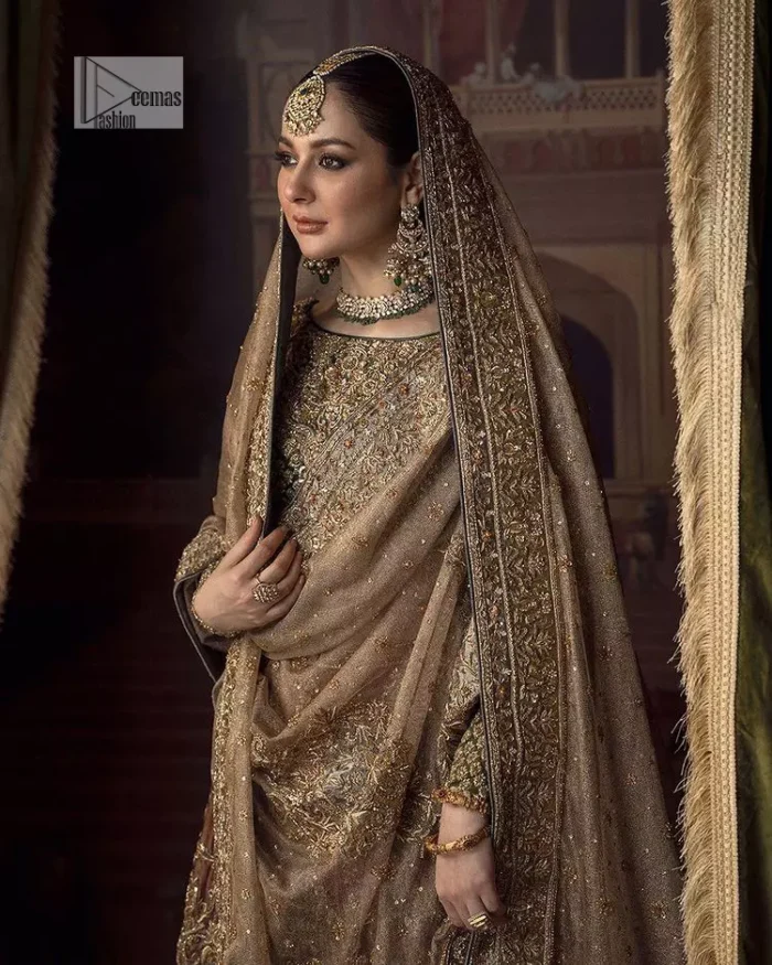This alluring outfit is surely any girl’s dream. The hazel blouse is a magnificent choice which is ornamented with golden embroidery that wins everyone's hearts at the very first glance. It is further intensified with tilla, dabka, kora, Kundan and stones. Hand-crafted details on the full sleeves of this beautiful nikah dress make it the epitome of beauty. It is coordinated with a lehenga which is decorated with the finest details that are your first priority for the wedding. The lehenga has a huge flare to fulfil the dreamy look. Complete this article with a dupatta that is adorned with four-sided embellished borders and sparkling sequins to make your day.
