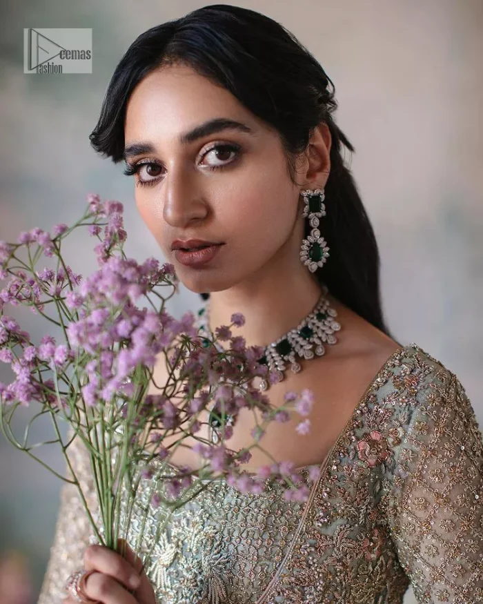 She wears a lilac colour as her wedding dress and looked stunning on her Nikah day. DeemasFashion presents this outfit in lilac colour to make your day like a flower. The maxi is adorned with golden and silver embroidery which is further enhanced with tilla, dabka, kora, Kundan and details of crystal to make the masterpiece a unique one. The square neckline of the maxi is also adorned with embroidery for giving a magical look. In addition to this, the full sleeves are also decorated to make your day lovely and charming. Paired up the following maxi with a lehenga having a border embellished. Complete this article with a dupatta framed with four-sided embellished borders and sequins sprayed all over. 