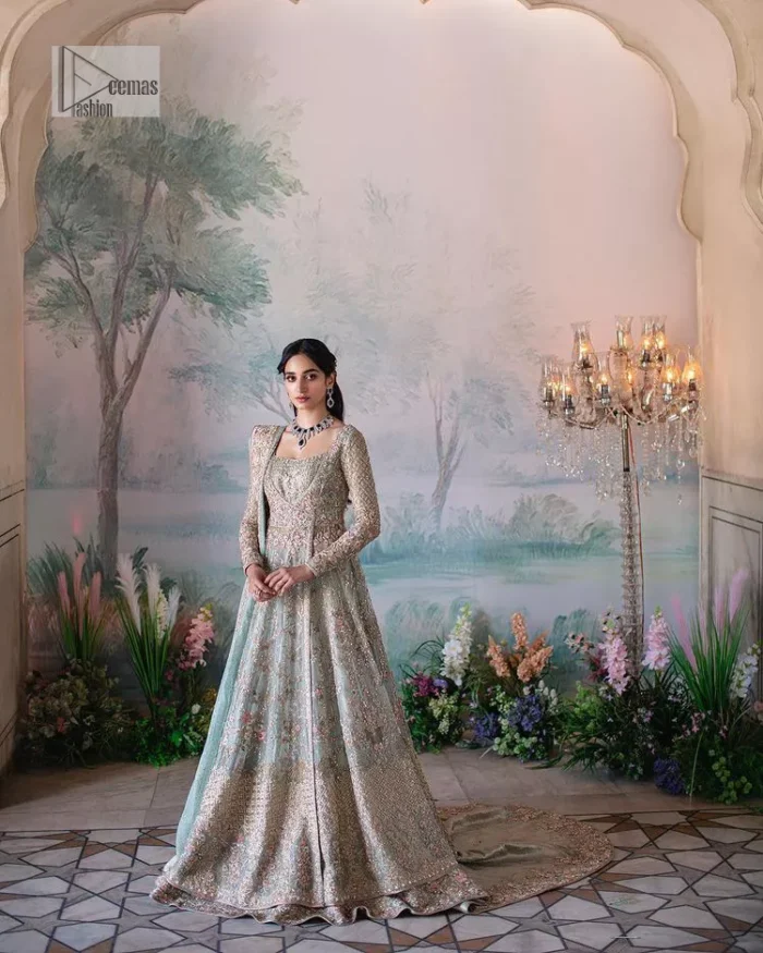 Unique embroidery designs to add some sparkle to your style on your Nikah! Light blue angrakha maxi with delicate multiple colour embroideries and intricate hand embellishments of tilla, dabka, kora, Kundan and crystals on the classic silhouette. Designed to flaunt your best features, the full sleeves carry beautiful embroidery with a square neckline. The following maxi along with the back train lehenga gives this outfit a unique look. Paired with a dreamy dupatta framed with embellished borders, this look is the epitome of ethereal and easy elegance.