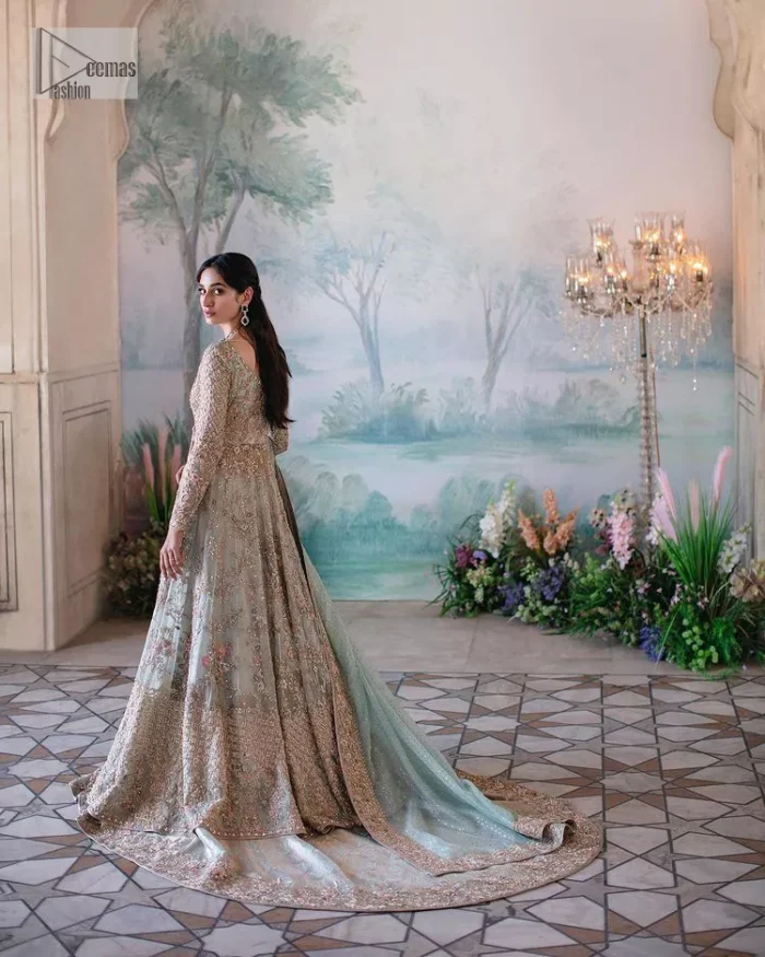 Unique embroidery designs to add some sparkle to your style on your Nikah! Light blue angrakha maxi with delicate multiple colour embroideries and intricate hand embellishments of tilla, dabka, kora, Kundan and crystals on the classic silhouette. Designed to flaunt your best features, the full sleeves carry beautiful embroidery with a square neckline. The following maxi along with the back train lehenga gives this outfit a unique look. Paired with a dreamy dupatta framed with embellished borders, this look is the epitome of ethereal and easy elegance.