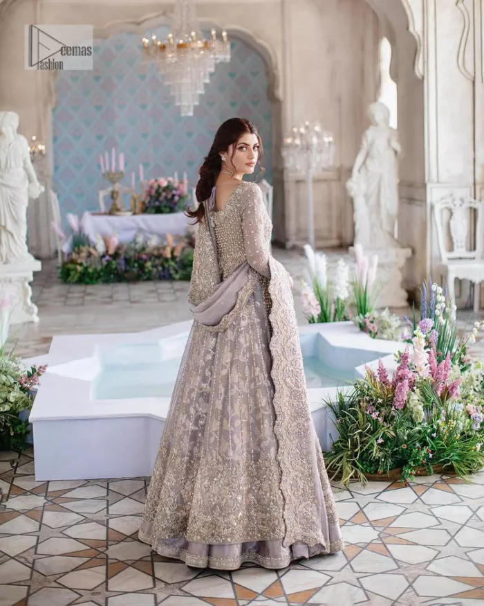 She wears a lilac colour as her wedding dress and looked stunning on her Nikah day. DeemasFashion presents this outfit in lilac colour to make your day like a flower. The maxi is adorned with golden and silver embroidery which is further enhanced with tilla, dabka, kora, Kundan and details of crystal to make the masterpiece a unique one. The square neckline of the maxi is also adorned with embroidery for giving a magical look. In addition to this, the full sleeves are also decorated to make your day lovely and charming. Paired up the following maxi with a lehenga having a border embellished. Complete this article with a dupatta framed with four-sided embellished borders and sequins sprayed all over. 
