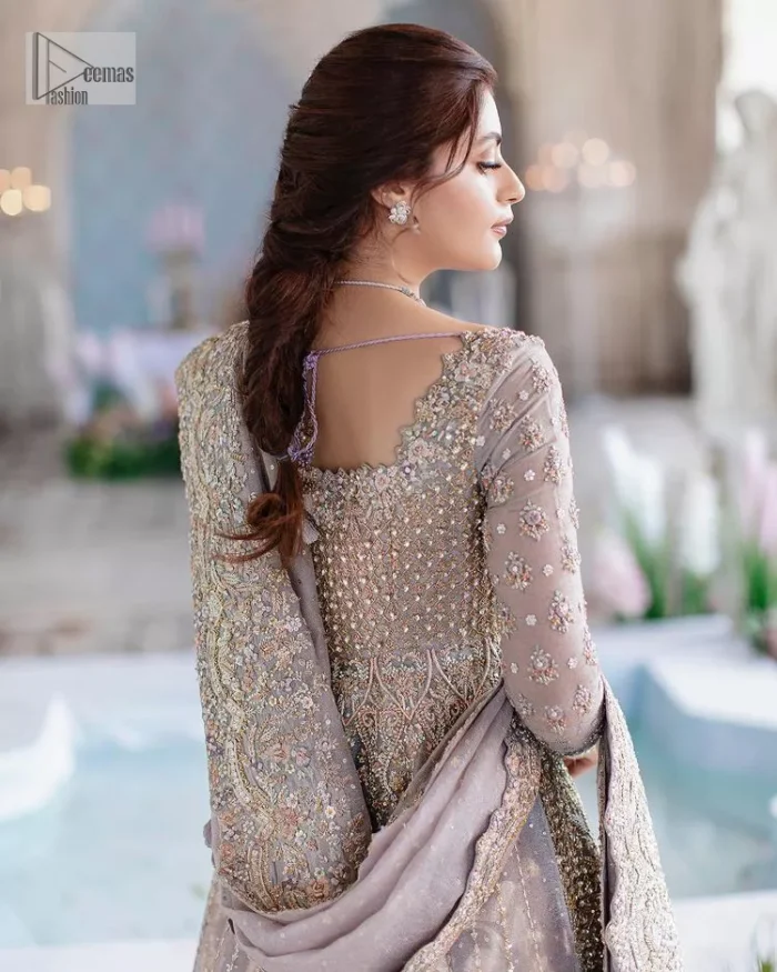 She wears a lilac colour as her wedding dress and looked stunning on her Nikah day. DeemasFashion presents this outfit in lilac colour to make your day like a flower. The maxi is adorned with golden and silver embroidery which is further enhanced with tilla, dabka, kora, Kundan and details of crystal to make the masterpiece a unique one. The square neckline of the maxi is also adorned with embroidery for giving a magical look. In addition to this, the full sleeves are also decorated to make your day lovely and charming. Paired up the following maxi with a lehenga having a border embellished. Complete this article with a dupatta framed with four-sided embellished borders and sequins sprayed all over. 