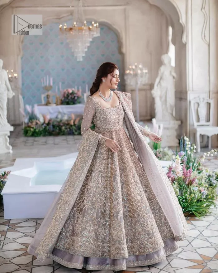 She wears a lilac colour as her wedding dress and looked stunning on her Nikah day. DeemasFashion presents this outfit in lilac colour to make your day like a flower. The maxi is adorned with golden and silver embroidery which is further enhanced with tilla, dabka, kora, Kundan and details of crystal to make the masterpiece a unique one. The square neckline of the maxi is also adorned with embroidery for giving a magical look. In addition to this, the full sleeves are also decorated to make your day lovely and charming. Paired up the following maxi with a lehenga having a border embellished. Complete this article with a dupatta framed with four-sided embellished borders and sequins sprayed all over. 