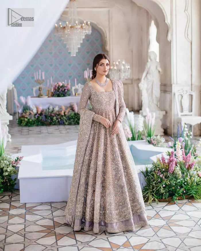 She wears a lilac colour as her wedding dress and looked stunning on her Nikah day. DeemasFashion presents this outfit in lilac colour to make your day like a flower. The maxi is adorned with golden and silver embroidery which is further enhanced with tilla, dabka, kora, Kundan and details of crystal to make the masterpiece a unique one. The square neckline of the maxi is also adorned with embroidery for giving a magical look. In addition to this, the full sleeves are also decorated to make your day lovely and charming. Paired up the following maxi with a lehenga having a border embellished. Complete this article with a dupatta framed with four-sided embellished borders and sequins sprayed all over. 