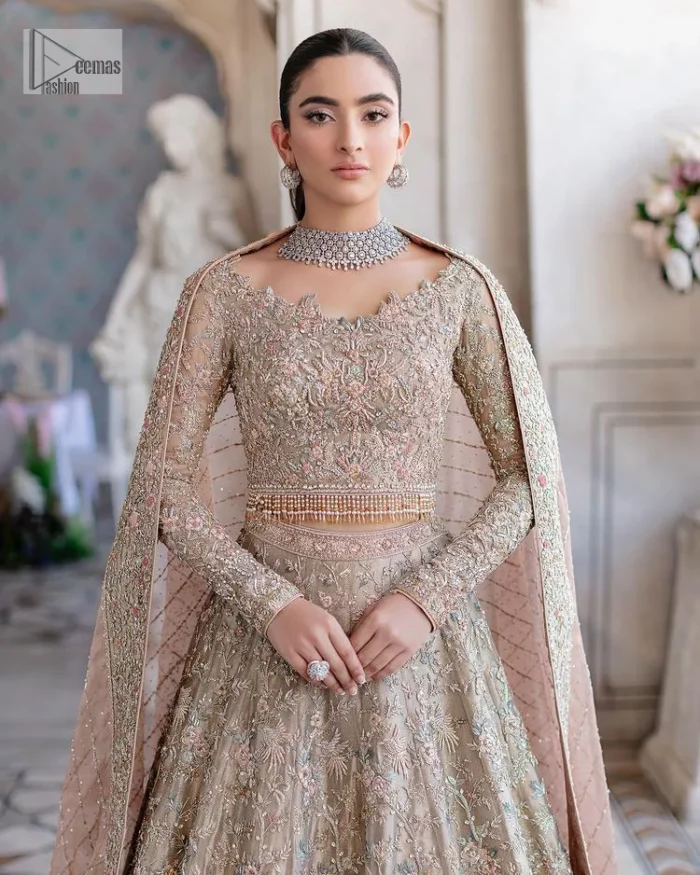 Carry the style that is your dream on your Nikah day with this classy article! A beautiful blouse in nude ivory colour is a perfect choice to pair with Lehenga. The blouse choli is emblazoned with silver embroidery and floral designs. Hand-crafted details of tilla, dabka, kora, Kundan and crystals make this choli a ravishing masterpiece. The boat shape neckline is a perfect choice to make this article super amazing. Further, the following blouse is maintain a balancing look of the bride with its full sleeves. It is handsomely systemized with a scalloped lehenga that is heavily adorned to win everyone's hearts at the very first glance with its charm and elegance. Finish this article with a dupatta its surface sprayed with sequin and beautifully framed by a heavily embellished floral border that is a perfect choice