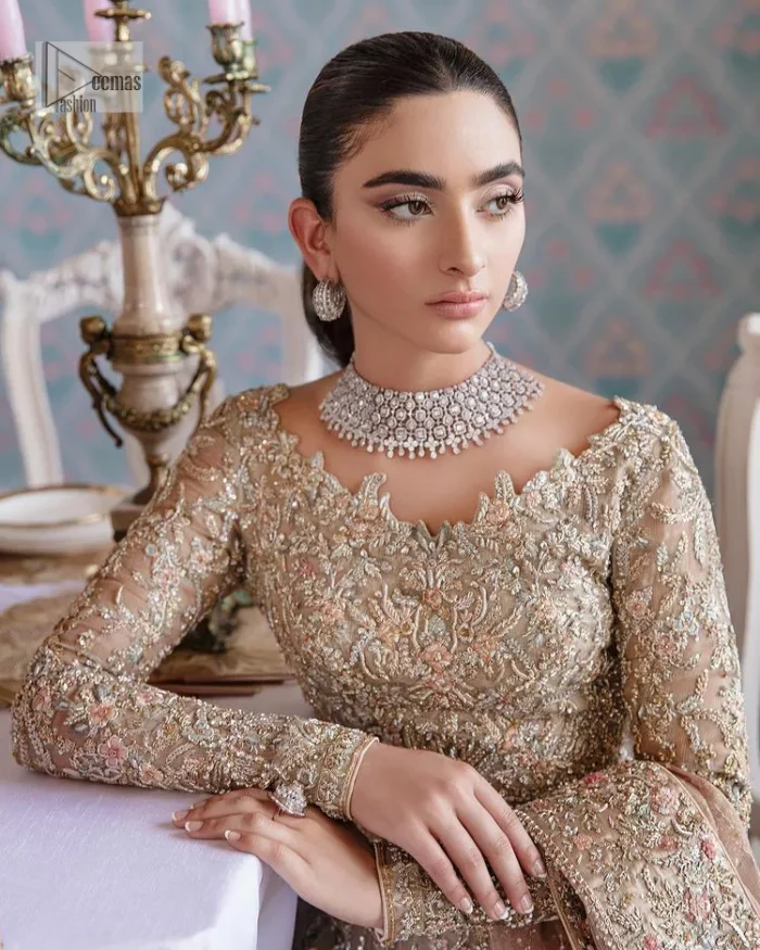 Carry the style that is your dream on your Nikah day with this classy article! A beautiful blouse in nude ivory colour is a perfect choice to pair with Lehenga. The blouse choli is emblazoned with silver embroidery and floral designs. Hand-crafted details of tilla, dabka, kora, Kundan and crystals make this choli a ravishing masterpiece. The boat shape neckline is a perfect choice to make this article super amazing. Further, the following blouse is maintain a balancing look of the bride with its full sleeves. It is handsomely systemized with a scalloped lehenga that is heavily adorned to win everyone's hearts at the very first glance with its charm and elegance. Finish this article with a dupatta its surface sprayed with sequin and beautifully framed by a heavily embellished floral border that is a perfect choice