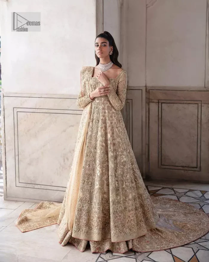 Ooze beauty and elegance in this simple yet amazing ensemble. This walima outfit in the off-white colour is a  magnificent look emblazoned with beautiful light golden embroidery which is further enhanced with tilla, dabka, kora, Kundan and the real magic of thread. The square neckline and full sleeves are unique in style and have classy look and perfect choice for the traditional bride. It is paired up with a lehenga which is adorned with beautiful embroidery. Father, the lehenga has a back-train to make this outfit lovely. Complete this with a dupatta framed with four-sided borders and sequins sprayed all over to add extra glam to this masterpiece.