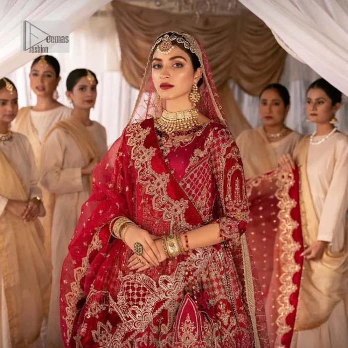 Enter the world of allurement with red shade, a gorgeous go-to dress for your big day to make you look classy and fabulous at the same time! A red organza base reception outfit is generously light golden embroidered with tilla, dabka, kora, Kundan and resham to form a beautifully composed lehenga, maxi and dupatta. The round neckline, three quarter sleeves make this outfit super amazing and charming. It is paired up with lehenga which is adorned with ting floral motifs. The can-can make this lehenga a dreamy real magic. Finish this look with dupatta, framed with a four sided borders. It is enhanced with sparkling of tiny floral motifs and sequins spray.