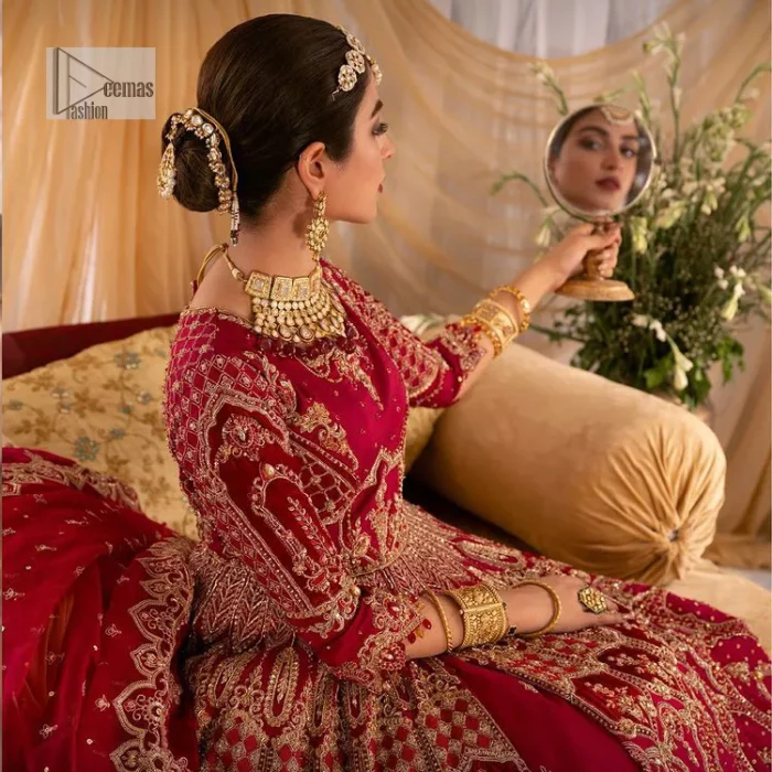 Enter the world of allurement with red shade, a gorgeous go-to dress for your big day to make you look classy and fabulous at the same time! A red organza base reception outfit is generously light golden embroidered with tilla, dabka, kora, Kundan and resham to form a beautifully composed lehenga, maxi and dupatta. The round neckline, three quarter sleeves make this outfit super amazing and charming. It is paired up with lehenga which is adorned with ting floral motifs. The can-can make this lehenga a dreamy real magic. Finish this look with dupatta, framed with a four sided borders. It is enhanced with sparkling of tiny floral motifs and sequins spray.