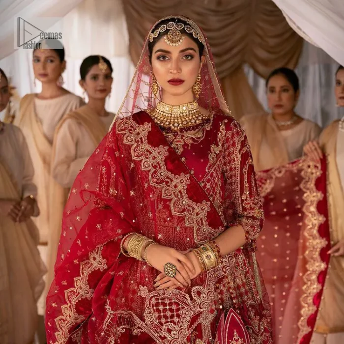 Enter the world of allurement with red shade, a gorgeous go-to dress for your big day to make you look classy and fabulous at the same time! A red organza base reception outfit is generously light golden embroidered with tilla, dabka, kora, Kundan and resham to form a beautifully composed lehenga, maxi and dupatta. The round neckline, three quarter sleeves make this outfit super amazing and charming. It is paired up with lehenga which is adorned with ting floral motifs. The can-can make this lehenga a dreamy real magic. Finish this look with dupatta, framed with a four sided borders. It is enhanced with sparkling of tiny floral motifs and sequins spray.
