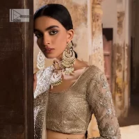 The fusion of this silver canvas decorated with vibrant contrasts is all you need to stun on your day! DeemasFashion presents this nikah wear in silver colour which is highlighted with tilla, dabka, kora, Kundan and the real magic of Zardozi. The round neckline of the following blouse has an ethnic charm. It is embellished with silver embroidery to make this masterpiece a dreamy one. The full sleeves style of the blouse also adds beauty to the outfit. It is paired up with a lehenga which is heavily embellished. The stunning dress in the Lehenga Choli style achieves the final charming look when paired with a dupatta in the same colour framed with four-sided borders and sequins sprayed all over. 