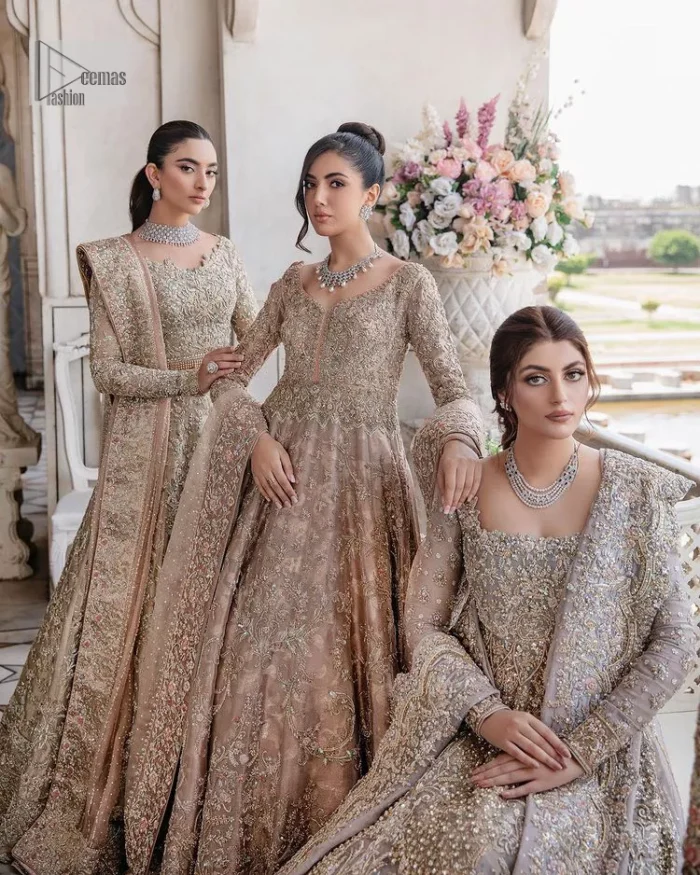 Make your Qabool Hai moment more memorable with this outfit by DeemasFashion. A dreamy statement of this dress proffers a soft pink hue with glamorous silver and golden embroidery.  It is further enhanced with tilla, dabka, kora, Kundan and the real magic of zardozi. V neckline enhances the overall glamour of this masterpiece. Intricate designs and fine details on the sleeves give a perfect finishing look to this maxi. The maxi is layered over a meticulously handcrafted lehnga which is bold enough to stand out in the crowd. Finish this article with a dupatta which is ornamented with four-sided borders and sequins sprayed all over which is a unique piece for your Nikah look. 