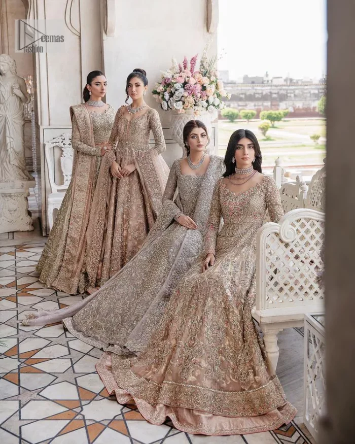 Make your Qabool Hai moment more memorable with this outfit by DeemasFashion. A dreamy statement of this dress proffers a soft pink hue with glamorous silver and golden embroidery.  It is further enhanced with tilla, dabka, kora, Kundan and the real magic of zardozi. V neckline enhances the overall glamour of this masterpiece. Intricate designs and fine details on the sleeves give a perfect finishing look to this maxi. The maxi is layered over a meticulously handcrafted lehnga which is bold enough to stand out in the crowd. Finish this article with a dupatta which is ornamented with four-sided borders and sequins sprayed all over which is a unique piece for your Nikah look. 
