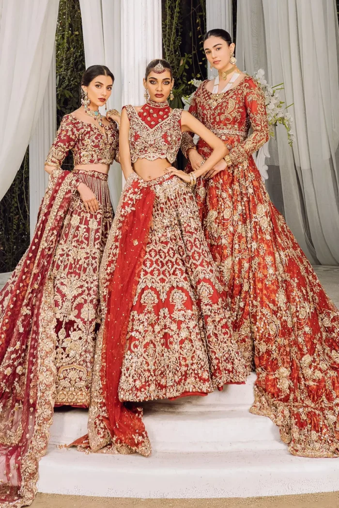 Feels just bright red on your Big day to make your day lovely and romantic. DeemasFashion presents this Pakistani reception wear for you in bright red colour which begins with a flared back train maxi. The maxi is attractively and laboriously adorned with golden embroidery that enhances tilla,dabka, kora and Kundan. In addition to this, the round neckline intensifies the beauty of this article when comes with full sleeves. The flared back train of the maxi is also heavily embellished. Complete this article with a dupatta in the same colour which is adorned with four-sided borders and tiny floral motifs, sequins spray all over to make you fresh on your Big day.