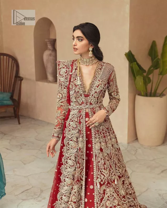 Classic and eye-catching! Made for stylish brides.  This reception wear in the bright red shade comes in a stunning open style and is hand-embellished with tilla,dabka, kora, Kundan and Zardozi details. The golden embroidery gives a royal touch to the dress. The V shape neckline gives you a dreamy appearance on the most important day of your life. Intricate designs and hand-crafted embellishments on full sleeves also make a look. It is systemized with a lehenga which has a huge flare and is adorned with embroidery. Complete this article with a dupatta framed with four-sided borders that is a perfect choice.