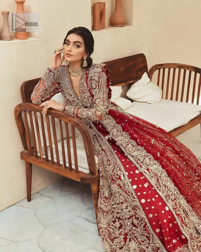 Classic and eye-catching! Made for stylish brides.  This reception wear in the bright red shade comes in a stunning open style and is hand-embellished with tilla,dabka, kora, Kundan and Zardozi details. The golden embroidery gives a royal touch to the dress. The V shape neckline gives you a dreamy appearance on the most important day of your life. Intricate designs and hand-crafted embellishments on full sleeves also make a look. It is systemized with a lehenga which has a huge flare and is adorned with embroidery. Complete this article with a dupatta framed with four-sided borders that is a perfect choice.