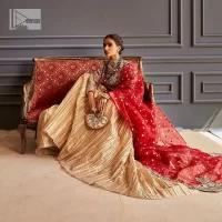 The magic of luxurious romantic outfits at your reception, giving out love and letting it come in. The Beautiful bright red short frock is adorned with classy golden embroidery and will look breathtaking on the traditional bride. The boat shape neckline makes this frock a glamorous choice to pair with the classy golden crushed lehenga. In addition to this, the following frock is enhanced with tilla, dabka, kora, Kundan and the real magic of zardozi. Crushed Lehenga paired with the Embellished frock enhances the overall Royal look of the outfit. The perfect stitching and crushed style make this Lehenga your first-ever priority. Complete this article with a scalloped dupatta that is embellished with four-sided borders and sequins sprayed all over.