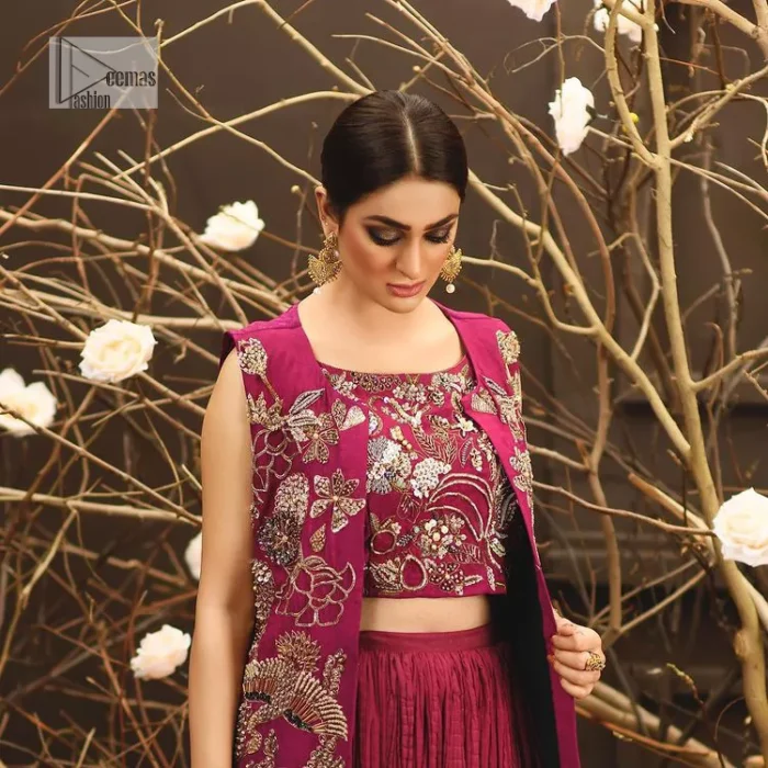 Sumptuously burgundy! This alluring outfit is surely any girl’s dream. DeemasFashion presents the three-piece outfit to make your event super bright. The blouse is handsomely laden with multiple colour embroidery. Beaming ornaments, zardozi, tilla,dabka, kora and Kundan make this blouse an epitome of grace. The boat shape neckline of the blouse a glamorous touch to this beautiful masterpiece. Paired up with a front open gown, hand-crafted beaming embellishments and luxury designs give a unique artistic look. The sleeveless style of the gown gives a royal appearance. Complete this article with a crushed skirt making it a perfect choice to pair with the blouse and gown.