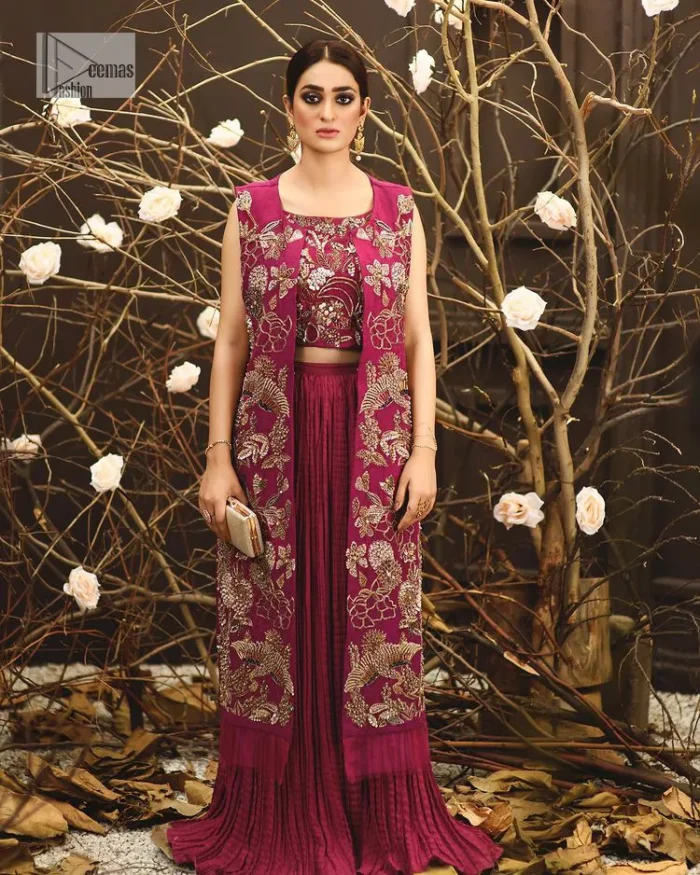 Sumptuously burgundy! This alluring outfit is surely any girl’s dream. DeemasFashion presents the three-piece outfit to make your event super bright. The blouse is handsomely laden with multiple colour embroidery. Beaming ornaments, zardozi, tilla,dabka, kora and Kundan make this blouse an epitome of grace. The boat shape neckline of the blouse a glamorous touch to this beautiful masterpiece. Paired up with a front open gown, hand-crafted beaming embellishments and luxury designs give a unique artistic look. The sleeveless style of the gown gives a royal appearance. Complete this article with a crushed skirt making it a perfect choice to pair with the blouse and gown.