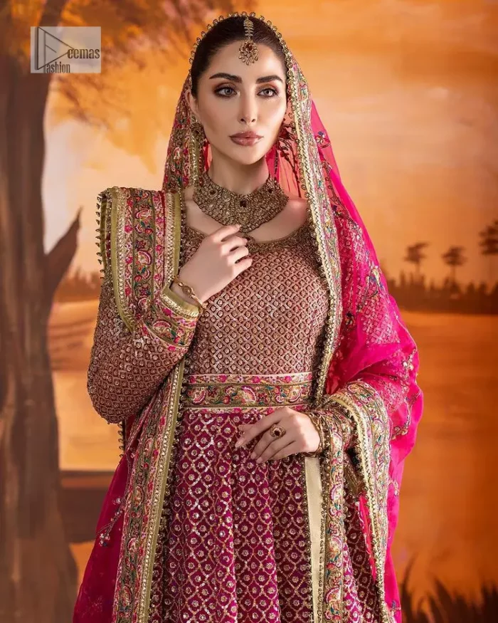 Experience the true essence of reception wear in alluring attires from DeemasFashion. The host pink pishwas is decorated with multiple colour embroidery which is handsomely enhanced with tilla, dabka, kora, Kundan and the real magic of Zardozi to make this masterpiece unique and charming. The finishing of boat shape neckline enhances the beauty of the attire. Furthermore, the full sleeves of the pishwas are a perfectly charming choice to pair with a Pishwas. It is coordinated with a jamawar lehenga whose border is adorned with beautiful embroidery. Complete this article with a dupatta framed with four-sided embellished borders and sequins sprayed all over.