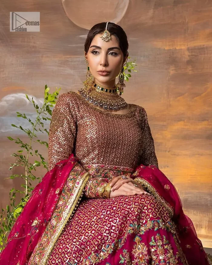 Experience the true essence of reception wear in alluring attires from DeemasFashion. The host pink pishwas is decorated with multiple colour embroidery which is handsomely enhanced with tilla, dabka, kora, Kundan and the real magic of Zardozi to make this masterpiece unique and charming. The finishing of boat shape neckline enhances the beauty of the attire. Furthermore, the full sleeves of the pishwas are a perfectly charming choice to pair with a Pishwas. It is coordinated with a jamawar lehenga whose border is adorned with beautiful embroidery. Complete this article with a dupatta framed with four-sided embellished borders and sequins sprayed all over.