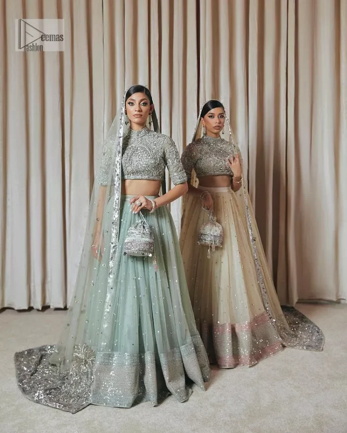 The perfect balance of simplicity and flamboyance is the essence of the beautiful Walima outfit. The blouse in off-white colour is beautifully embellished with Dabka, Tilla, Zardozi and delicate yet intricate crystal work. The beautiful classy artistic half sleeves design maintains the charm of this blouse. The beautiful outfit is epitome of beauty by its high neckline . It is paired up with flared lehenga in the same colour, framed with a sequins sprayed all over. Further, beautiful silver embroidery on the four sided border of the dupatta will enhance the overall magnificent look.
