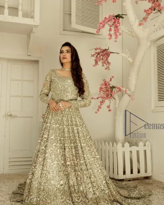 It was love at first swipe! Present this olive green back train maxi which is laboriously hand-rendered with silver embroidery to make you a pure soulful bride. It is enhanced with tilla, dabka, kora and Kundan. The illusion neckline adds more beauty to this walima wear when comes with full sleeves. The back train flare is made just for you to catch more and more love from your loved ones. Complete this walima wear with a dupatta in the same colour which is handsomely embellished with a four-sided heavy border and sequins sprayed all over to receive more love.