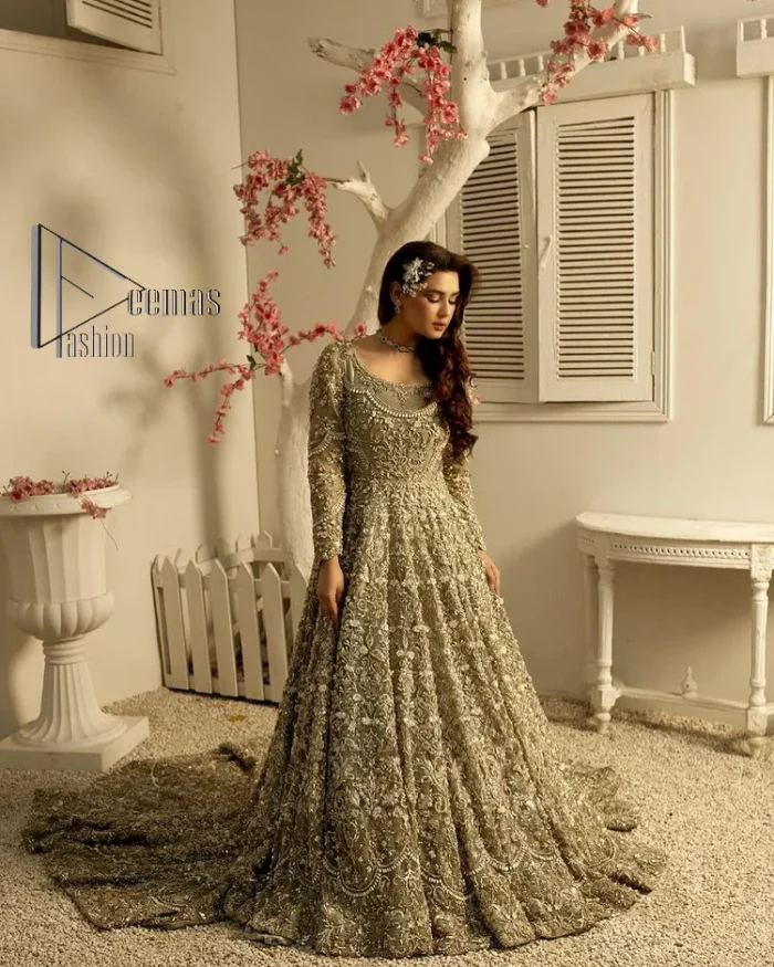 It was love at first swipe! Present this olive green back train maxi which is laboriously hand-rendered with silver embroidery to make you a pure soulful bride. It is enhanced with tilla, dabka, kora and Kundan. The illusion neckline adds more beauty to this walima wear when comes with full sleeves. The back train flare is made just for you to catch more and more love from your loved ones. Complete this walima wear with a dupatta in the same colour which is handsomely embellished with a four-sided heavy border and sequins sprayed all over to receive more love.