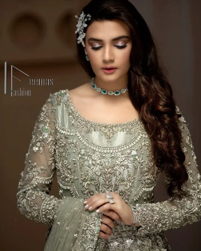 It was love at first swipe! Present this olive green back train maxi which is laboriously hand-rendered with silver embroidery to make you a pure soulful bride. It is enhanced with tilla, dabka, kora and Kundan. The illusion neckline adds more beauty to this walima wear when comes with full sleeves. The back train flare is made just for you to catch more and more love from your loved ones. Complete this walima wear with a dupatta in the same colour which is handsomely embellished with a four-sided heavy border and sequins sprayed all over to receive more love.
