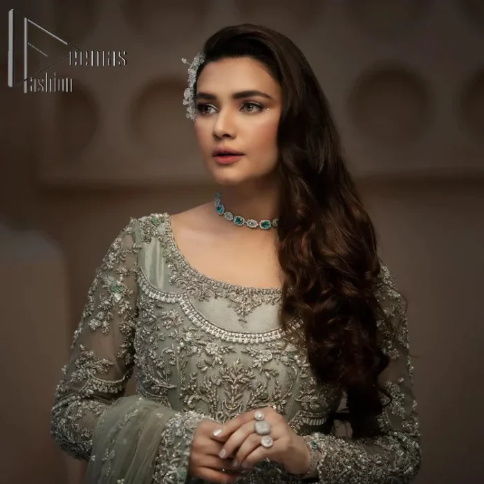 It was love at first swipe! Present this olive green back train maxi which is laboriously hand-rendered with silver embroidery to make you a pure soulful bride. It is enhanced with tilla, dabka, kora and Kundan. The illusion neckline adds more beauty to this walima wear when comes with full sleeves. The back train flare is made just for you to catch more and more love from your loved ones. Complete this walima wear with a dupatta in the same colour which is handsomely embellished with a four-sided heavy border and sequins sprayed all over to receive more love.