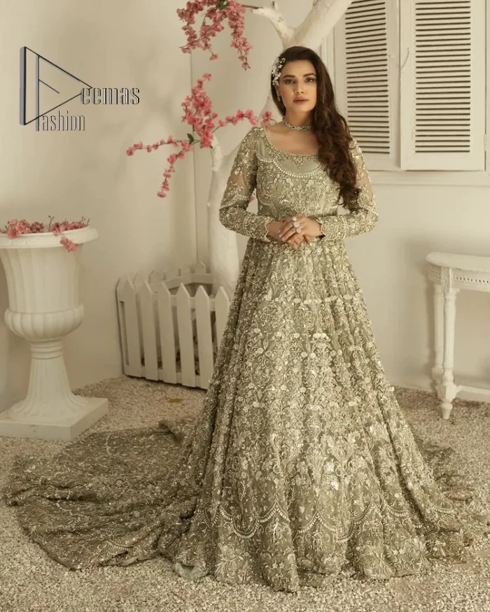 It was love at first swipe! Present this olive green back train maxi which is laboriously hand-rendered with silver embroidery to make you a pure soulful bride. It is enhanced with tilla, dabka, kora and Kundan. The illusion neckline adds more beauty to this walima wear when comes with full sleeves. The back train flare is made just for you to catch more and more love from your loved ones. Complete this walima wear with a dupatta in the same colour which is handsomely embellished with a four-sided heavy border and sequins sprayed all over to receive more love.