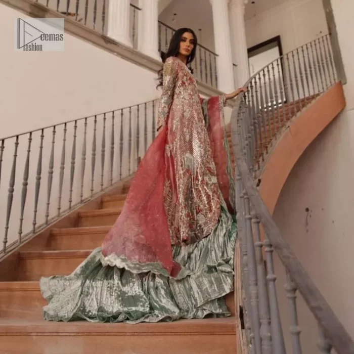 The latest elegant embroidered maxi in peach colour with magnificence embroidered work. The front open maxi is attractively laden with light golden embroidery to make this masterpiece unique and charming. Purely balanced raw silk maxi is presented with an ethereal blend of Resham, naqshi, kora, dabka and Mukesh carved with stones. Full Sleeves of the following maxi are also heavily embroidered. The round neckline gives it a magical look. It is coordinated with crushed lehenga in a pistachio green colour to create a ravishing Nikkah bride look. This crushed lehenga is paired with embroidered dupatta detailed with a splash of sequins and embroidered borders.