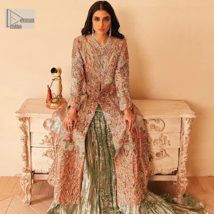 The latest elegant embroidered maxi in peach colour with magnificence embroidered work. The front open maxi is attractively laden with light golden embroidery to make this masterpiece unique and charming. Purely balanced raw silk maxi is presented with an ethereal blend of Resham, naqshi, kora, dabka and Mukesh carved with stones. Full Sleeves of the following maxi are also heavily embroidered. The round neckline gives it a magical look. It is coordinated with crushed lehenga in a pistachio green colour to create a ravishing Nikkah bride look. This crushed lehenga is paired with embroidered dupatta detailed with a splash of sequins and embroidered borders.