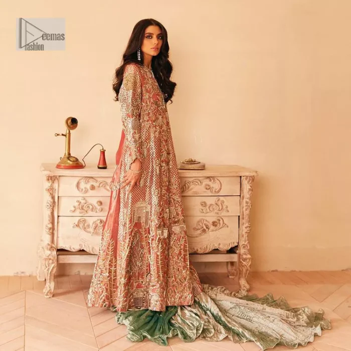 The latest elegant embroidered maxi in peach colour with magnificence embroidered work. The front open maxi is attractively laden with light golden embroidery to make this masterpiece unique and charming. Purely balanced raw silk maxi is presented with an ethereal blend of Resham, naqshi, kora, dabka and Mukesh carved with stones. Full Sleeves of the following maxi are also heavily embroidered. The round neckline gives it a magical look. It is coordinated with crushed lehenga in a pistachio green colour to create a ravishing Nikkah bride look. This crushed lehenga is paired with embroidered dupatta detailed with a splash of sequins and embroidered borders.