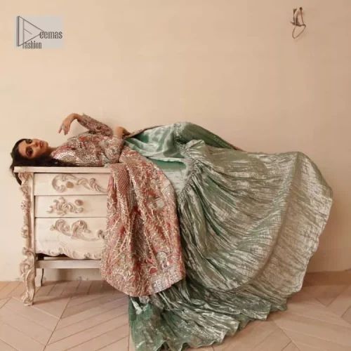 The latest elegant embroidered maxi in peach colour with magnificence embroidered work. The front open maxi is attractively laden with