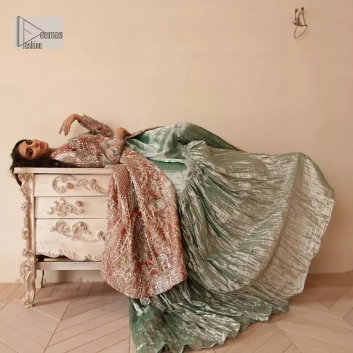 The latest elegant embroidered maxi in peach colour with magnificence embroidered work. The front open maxi is attractively laden with light golden embroidery to make this masterpiece unique and charming. Purely balanced raw silk maxi is presented with an ethereal blend of Resham, naqshi, kora, dabka and Mukesh carved with stones. Full Sleeves of the following maxi are also heavily embroidered. The round neckline gives it a magical look. It is coordinated with crushed lehenga in a pistachio green colour to create a ravishing Nikkah bride look. This crushed lehenga is paired with embroidered dupatta detailed with a splash of sequins and embroidered borders.