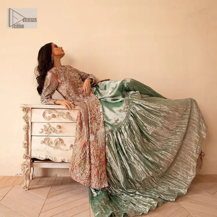 The latest elegant embroidered maxi in peach colour with magnificence embroidered work. The front open maxi is attractively laden with light golden embroidery to make this masterpiece unique and charming. Purely balanced raw silk maxi is presented with an ethereal blend of Resham, naqshi, kora, dabka and Mukesh carved with stones. Full Sleeves of the following maxi are also heavily embroidered. The round neckline gives it a magical look. It is coordinated with crushed lehenga in a pistachio green colour to create a ravishing Nikkah bride look. This crushed lehenga is paired with embroidered dupatta detailed with a splash of sequins and embroidered borders.