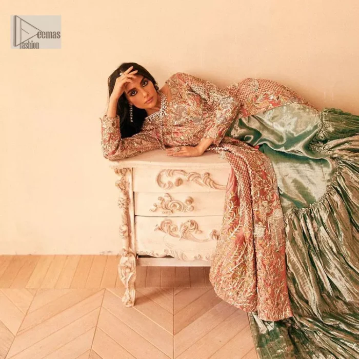 The latest elegant embroidered maxi in peach colour with magnificence embroidered work. The front open maxi is attractively laden with light golden embroidery to make this masterpiece unique and charming. Purely balanced raw silk maxi is presented with an ethereal blend of Resham, naqshi, kora, dabka and Mukesh carved with stones. Full Sleeves of the following maxi are also heavily embroidered. The round neckline gives it a magical look. It is coordinated with crushed lehenga in a pistachio green colour to create a ravishing Nikkah bride look. This crushed lehenga is paired with embroidered dupatta detailed with a splash of sequins and embroidered borders.