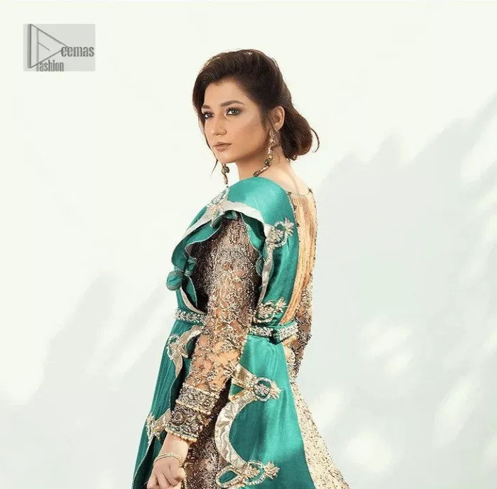 Celebrate your party with a bang and steal everyone's heart. The beautiful blouse in teal green shade comes in organza fabric. The boat shape neckline and full sleeves of this organza blouse are emblazoned with luxury details and intricate designs. Graceful golden embroidery that enhances with tilla, dabka, kora, Kundan, Zardozi and crystals to give a perfect finishing look to the blouse. It is organized with a back train lehenga which is heavily adorned with embroidery to make this masterpiece super aesthetic. Finish this outfit with a scalloped dupatta having four-sided embellished borders for a fine finishing look.