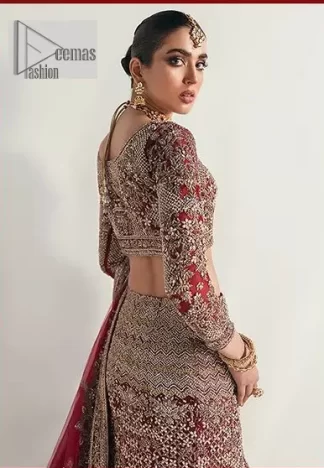 Walk with style at your reception and let the people follow! A stunning wine red blouse is embellished with intricate detailing and finished with light golden embroidery. It is further enhanced with the glorious amalgamation of zardozi, dabka, tilla, and elaborate stonework. Featuring a delicately embellished round neckline highlighted with zardozi detailing. The three-quarter sleeves of the following blouse give this outfit a unique look.  It is paired with a heavily embellished fish-cut lehenga with floral patterns that helps to sustain a traditional craft. Its dupatta is made from wine red net. Enveloping the sequin sprayed dupatta framed with a four-sided border that added divine pleasure to the entire article.