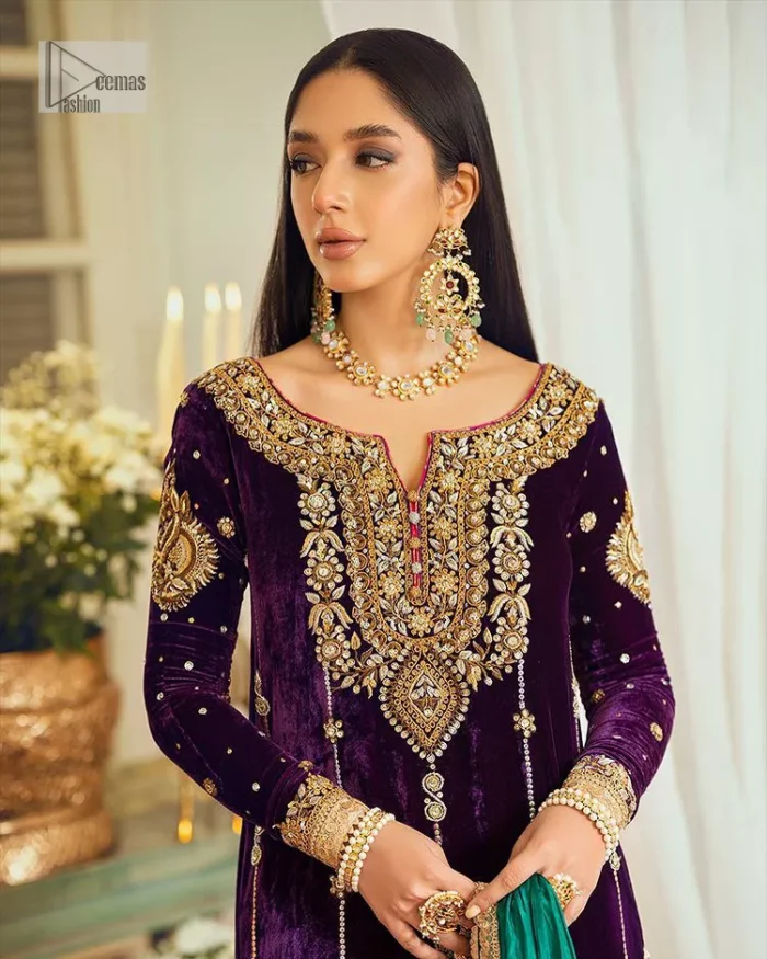Dress yourself up in glamorous ensembles. DeemasFaashion presents this beautiful party outfit in plum colour. It is highlighted with golden embroidery which is further enhanced with tilla, dabka, kora, Kundan and the real magic of zardozi. The full sleeves are embellished with sequins spray and floral motifs. In addition to this, the embroidered neckline makes this outfit more pretty. It is paired with maroon trousers with beautiful and stunning borders to balance the article. Complete this article with a dupatta in green and plum colour to fulfil the aesthetic look. 
