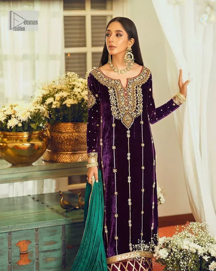 Dress yourself up in glamorous ensembles. DeemasFaashion presents this beautiful party outfit in plum colour. It is highlighted with golden embroidery which is further enhanced with tilla, dabka, kora, Kundan and the real magic of zardozi. The full sleeves are embellished with sequins spray and floral motifs. In addition to this, the embroidered neckline makes this outfit more pretty. It is paired with maroon trousers with beautiful and stunning borders to balance the article. Complete this article with a dupatta in green and plum colour to fulfil the aesthetic look. 