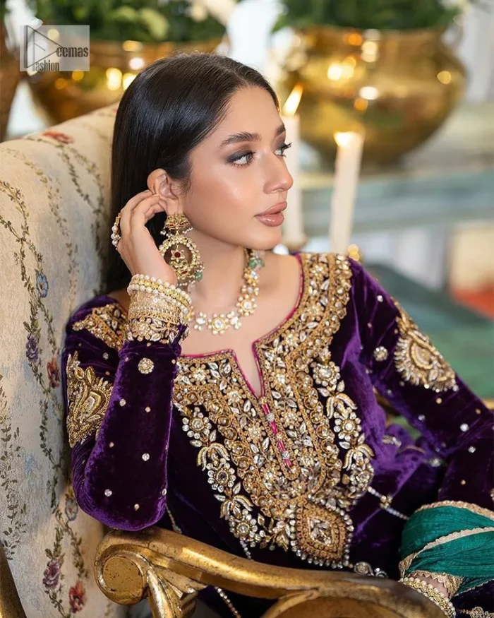 Dress yourself up in glamorous ensembles. DeemasFaashion presents this beautiful party outfit in plum colour. It is highlighted with golden embroidery which is further enhanced with tilla, dabka, kora, Kundan and the real magic of zardozi. The full sleeves are embellished with sequins spray and floral motifs. In addition to this, the embroidered neckline makes this outfit more pretty. It is paired with maroon trousers with beautiful and stunning borders to balance the article. Complete this article with a dupatta in green and plum colour to fulfil the aesthetic look. 