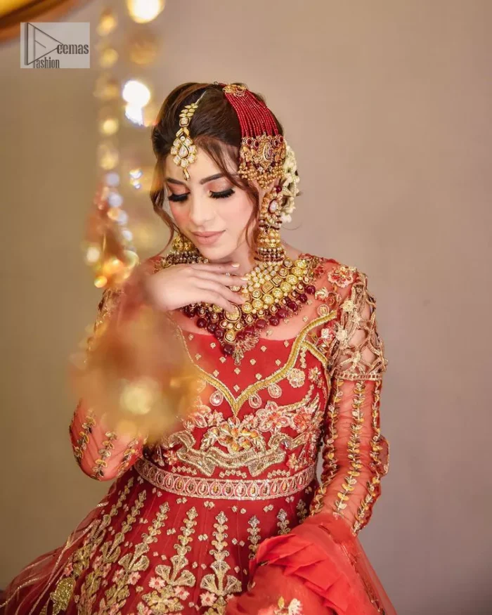The deep orange colour is the perfect feminine and delicate shade with its meticulously crafted untruth. The stunning maxi is ornamented with tilla, dabka, kora, Kundan, Zardozi and crystals. Embroidery is done in the shade of gold.  The illusion neckline of the maxi just steals everyone's heart. Further, the full sleeves of the maxi are also decorated with geometric patterns. The frill of the following maxi gives a perfectly glamorous look to the whole reception wear. It is paired up with a dupatta which is adorned with floral motifs all over.