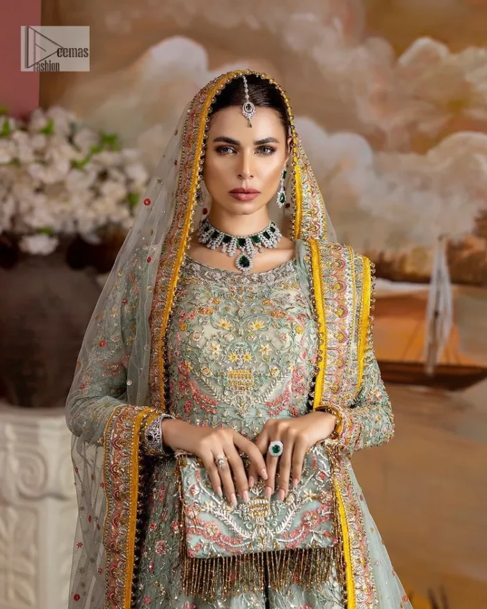 Enhance your beauty by dressing in magic. The most beautiful day of your life deserves an overall dome of embodiment, which is why you need an aqua-blue Anarkali to make you look stunning as a bride. The aqua blue, Anarkali and lehenga are hand-rendered in multiple colour embroidery and are further enhanced with pearls, nakshi, Sitara, tilla, kora, Zardozi and dabka.  The round neckline of the following Anarkali defines the beauty and charm of this unique article. Furthermore, the full sleeves are adorned with floral patterns. It is paired up with lehenga which is ornamented with a heavily embellished border to make this masterpiece unique. Complete this nikah wear with a dupatta adorned with four-sided embellished borders and tiny motifs sprinkled all over.