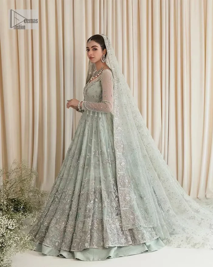 Exquisitely designed ensembles with delicate embroideries & traditional embellishments for nikah outfit statements. This beautiful maxi that comes in aqua blue colour is beautifully embellished with crystals and zardozi work. Beads, motifs,tilla, dabka, sequins, and shimmering adornments enhance the overall charm of this alluring maxi. Perfect stitching and intricate details give a royal appearance to the Bride. The bodice has a delicate and feminine V shape neckline with embellished full sleeves. Paired with lehnga and an alluring dupatta with a heavy spray of sparkling sequins and a detailed head embellished border to make your day super charming.