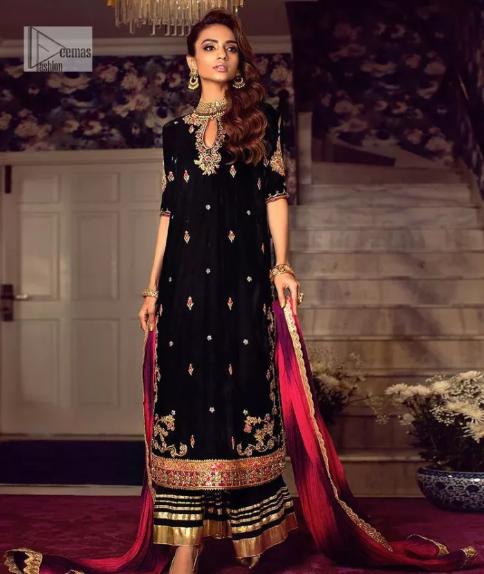 This outfit glam up in our detailed embroidered fabrics made to make you shine for every occasion. The black long shirt in premium quality velvet is beautifully decorated with multiple colour embroidery which is further enhanced with tilla, dabka, kora, Kundan and the real magic of Zardozi. The following shirt has an embellished neckline to meet the trending grace. Further, the half sleeves are adorned with floral motifs. It is coordinated with sharara in the same colour to balance the overall royal look of this party wear. Complete this article with a dupatta in the double shade that is a beautiful piece for a bridesmaid who has a unique taste.