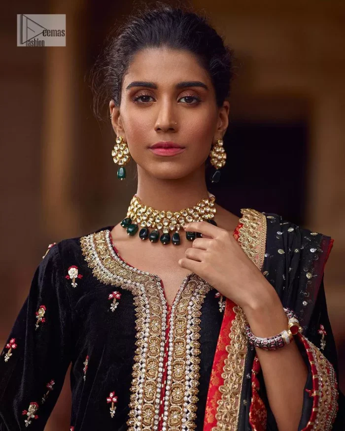 This outfit glam up in our detailed embroidered fabrics made to make you shine for every occasion. The black long shirt in premium quality velvet is beautifully decorated with multiple colour embroidery which is further enhanced with tilla, dabka, kora, Kundan and the real magic of Zardozi. The following shirt has an embellished neckline to meet the trending grace. Further, the half sleeves are adorned with floral motifs. It is coordinated with sharara in the same colour to balance the overall royal look of this party wear. Complete this article with a dupatta in the double shade that is a beautiful piece for a bridesmaid who has a unique taste.